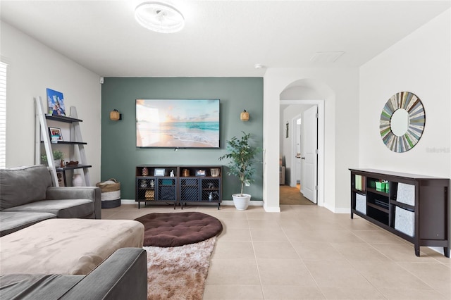 5659 Woodland Sage Dr, Sarasota, FL 34238 - living area featuring light tile patterned flooring, arched walkways, and baseboards