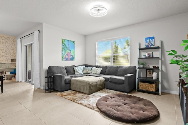 5659 Woodland Sage Dr, Sarasota, FL 34238 - living room with light tile patterned floors, a textured ceiling, and baseboards