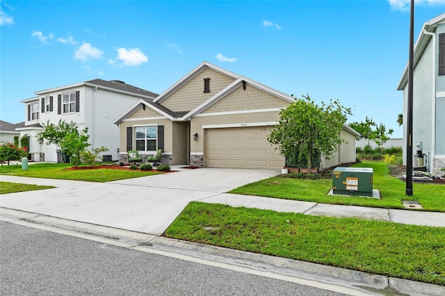 5659 Woodland Sage Dr, Sarasota, FL 34238 - view of front of house featuring an attached garage, a front yard, driveway, stucco siding, and stone siding