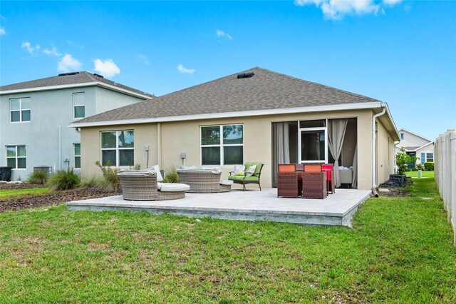 5659 Woodland Sage Dr, Sarasota, FL 34238 - rear view of property featuring an outdoor hangout area, stucco siding, a patio, a shingled roof, and a yard