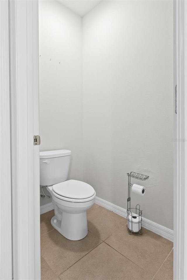 5659 Woodland Sage Dr, Sarasota, FL 34238 - bathroom featuring toilet, baseboards, and tile patterned flooring