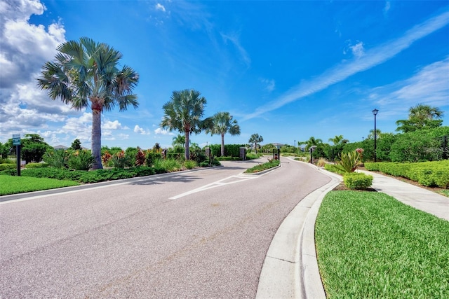 5659 Woodland Sage Dr, Sarasota, FL 34238 - view of asphalt road with street lighting, curbs, and sidewalks