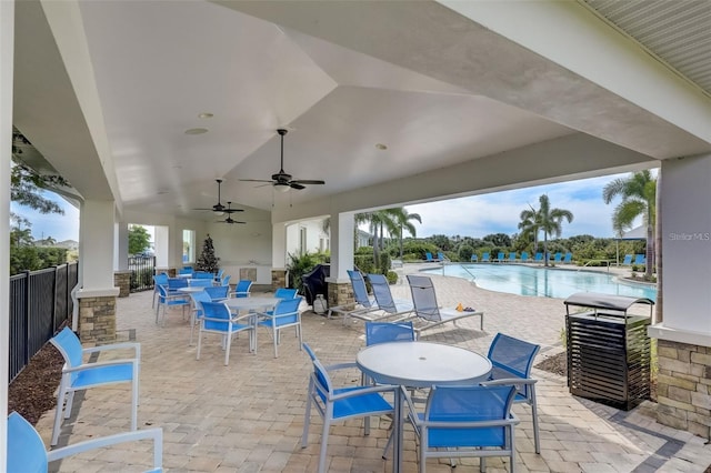 5659 Woodland Sage Dr, Sarasota, FL 34238 - view of patio featuring outdoor dining area, a ceiling fan, and a community pool