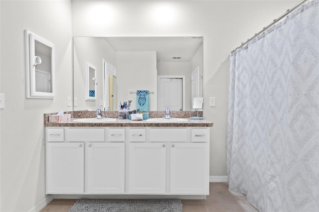 5659 Woodland Sage Dr, Sarasota, FL 34238 - full bath featuring double vanity, tile patterned flooring, and baseboards