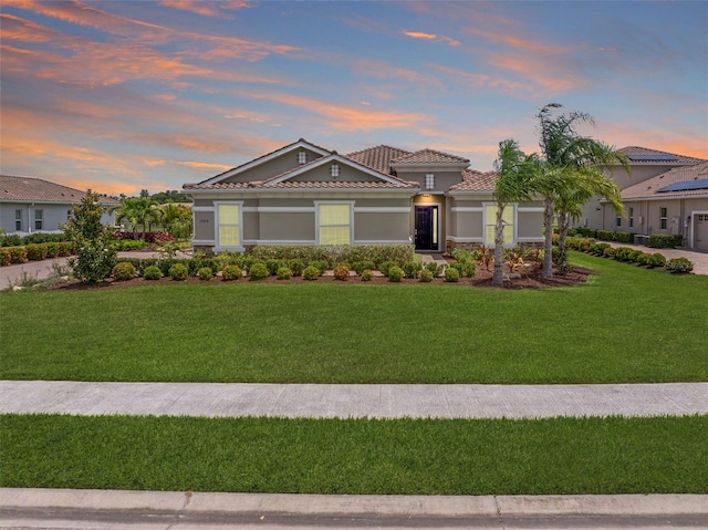 7508 Ripetta St, Sarasota, FL 34240 - mediterranean / spanish-style home featuring a front yard, a tiled roof, and stucco siding