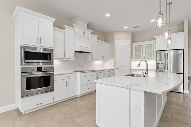 7508 Ripetta St, Sarasota, FL 34240 - kitchen featuring stainless steel appliances, a sink, backsplash, white cabinetry, and recessed lighting