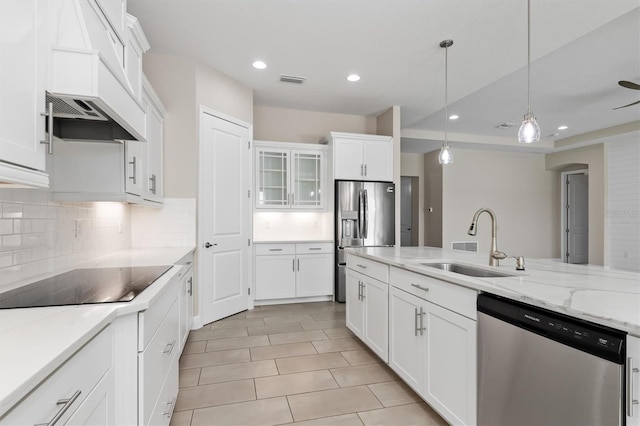 7508 Ripetta St, Sarasota, FL 34240 - kitchen featuring appliances with stainless steel finishes, a sink, tasteful backsplash, recessed lighting, and white cabinets