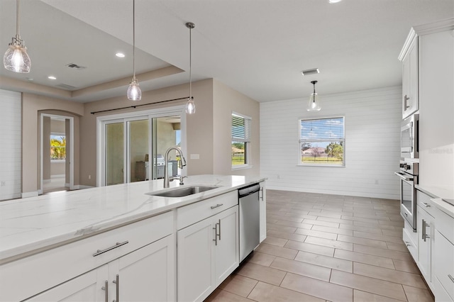 7508 Ripetta St, Sarasota, FL 34240 - kitchen featuring a sink, stainless steel appliances, plenty of natural light, light stone counters, and recessed lighting