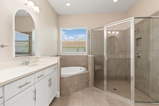 7508 Ripetta St, Sarasota, FL 34240 - full bath with tile patterned floors, vanity, a bath, a shower stall, and recessed lighting