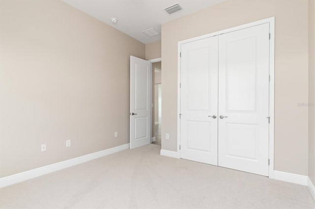 7508 Ripetta St, Sarasota, FL 34240 - unfurnished bedroom featuring light colored carpet, a closet, and baseboards
