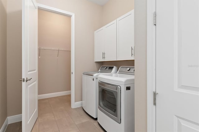 7508 Ripetta St, Sarasota, FL 34240 - laundry area featuring washer and clothes dryer, cabinet space, and baseboards