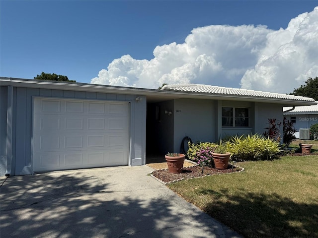 3673 Somerville Dr Unit 1510, Sarasota, FL 34232 - ranch-style home featuring central air condition unit, an attached garage, stucco siding, concrete driveway, and a front yard