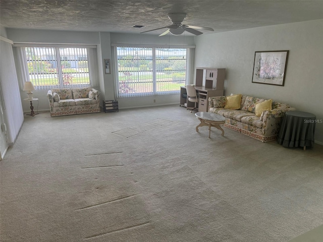 3673 Somerville Dr Unit 1510, Sarasota, FL 34232 - carpeted living area with ceiling fan, plenty of natural light, baseboards, and a textured ceiling