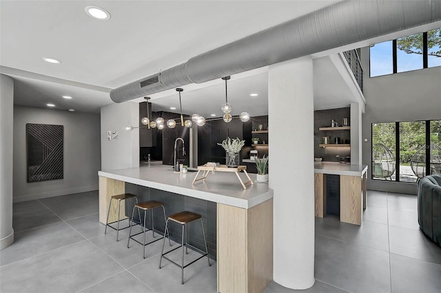 512 Treasure Boat Way, Sarasota, FL 34242 - kitchen with a kitchen bar, modern cabinets, healthy amount of natural light, tile patterned flooring, and recessed lighting
