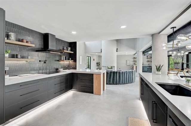 512 Treasure Boat Way, Sarasota, FL 34242 - kitchen with wall chimney exhaust hood, open shelves, tasteful backsplash, black electric cooktop, and light countertops