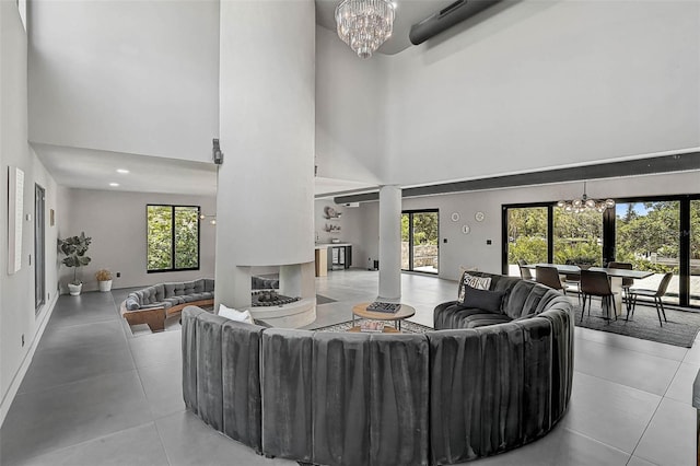 512 Treasure Boat Way, Sarasota, FL 34242 - tiled living area featuring a chandelier, a towering ceiling, and healthy amount of natural light