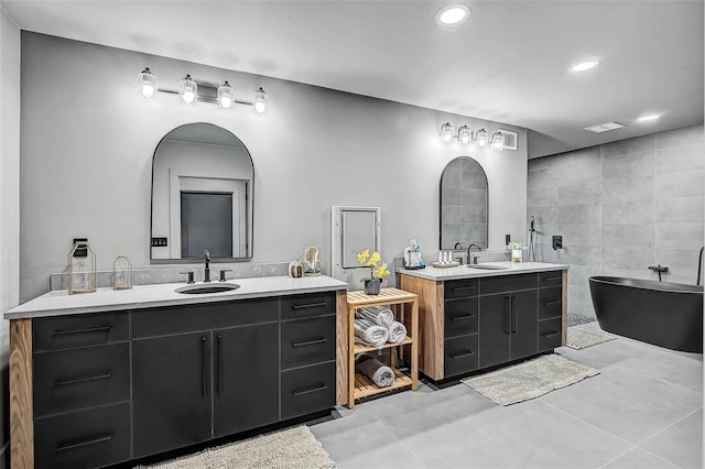 512 Treasure Boat Way, Sarasota, FL 34242 - bathroom with two vanities, a soaking tub, tile walls, recessed lighting, and concrete floors