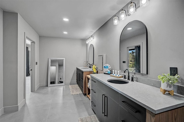 512 Treasure Boat Way, Sarasota, FL 34242 - full bathroom featuring two vanities, finished concrete floors, and recessed lighting