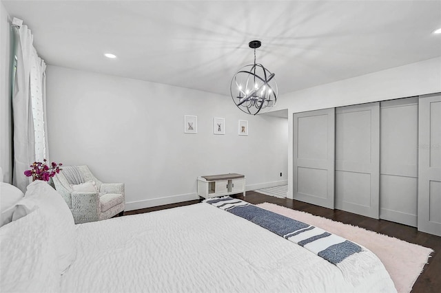 512 Treasure Boat Way, Sarasota, FL 34242 - bedroom with a chandelier, dark wood-style flooring, recessed lighting, and a closet