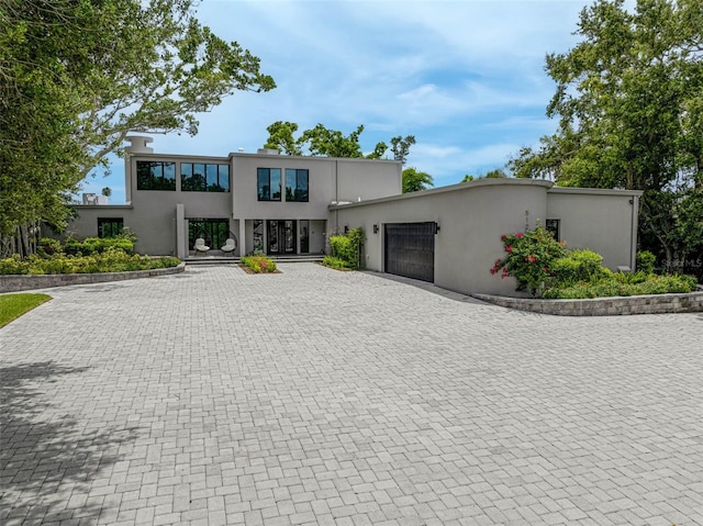 512 Treasure Boat Way, Sarasota, FL 34242 - modern home featuring an attached garage, decorative driveway, and stucco siding