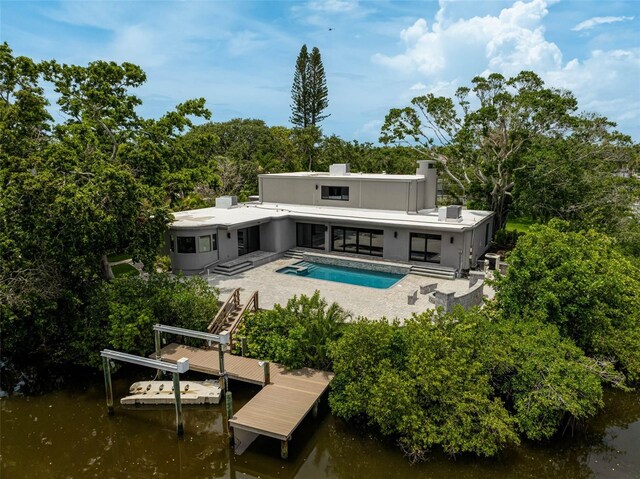 512 Treasure Boat Way, Sarasota, FL 34242 - back of house featuring a water view, an outdoor pool, and a patio area