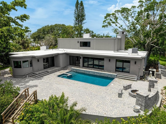 512 Treasure Boat Way, Sarasota, FL 34242 - back of house featuring a patio, a pool with connected hot tub, a chimney, and stucco siding