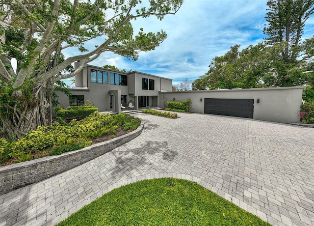 512 Treasure Boat Way, Sarasota, FL 34242 - view of front of home with stucco siding, a garage, and decorative driveway