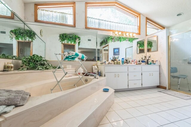 418 W Holly Dr, Orange City, FL 32763 - bathroom with a stall shower, vanity, a bath, tile patterned floors, and high vaulted ceiling