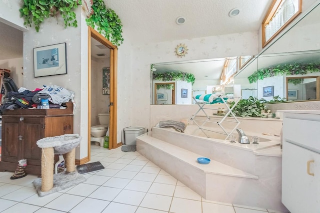418 W Holly Dr, Orange City, FL 32763 - bathroom with toilet, vanity, a bath, tile patterned floors, and a textured ceiling