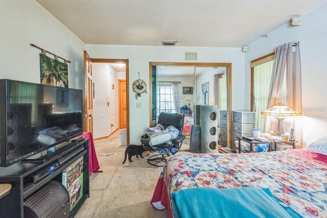 418 W Holly Dr, Orange City, FL 32763 - carpeted bedroom with a textured ceiling and a closet