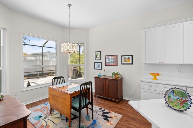 5110 19th Ave W, Bradenton, FL 34209 - dining space featuring a chandelier, dark wood finished floors, and baseboards