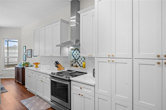 5110 19th Ave W, Bradenton, FL 34209 - kitchen featuring electric range, wall chimney exhaust hood, backsplash, white cabinetry, and dark wood finished floors