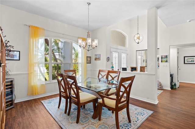 5110 19th Ave W, Bradenton, FL 34209 - dining area with a chandelier, wood finished floors, baseboards, and high vaulted ceiling
