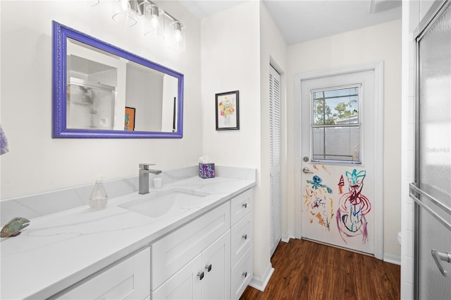 5110 19th Ave W, Bradenton, FL 34209 - full bath featuring vanity, wood finished floors, baseboards, an enclosed shower, and toilet