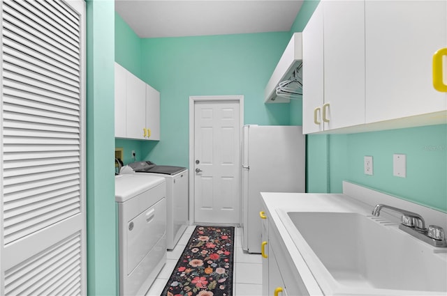 5110 19th Ave W, Bradenton, FL 34209 - laundry room featuring cabinet space, washer and dryer, and light tile patterned floors