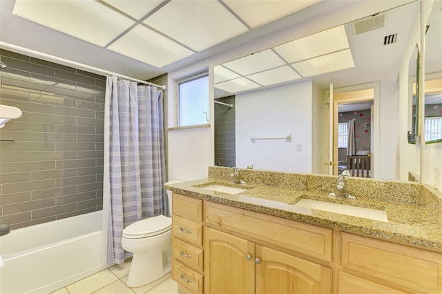 4155 Center Gate Blvd, Sarasota, FL 34233 - full bath with tile patterned floors, toilet, double vanity, and shower / bath combo with shower curtain