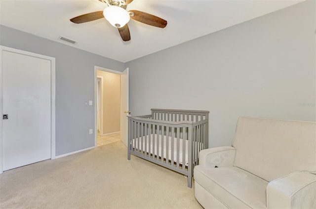 4155 Center Gate Blvd, Sarasota, FL 34233 - carpeted bedroom featuring a ceiling fan, baseboards, and a crib
