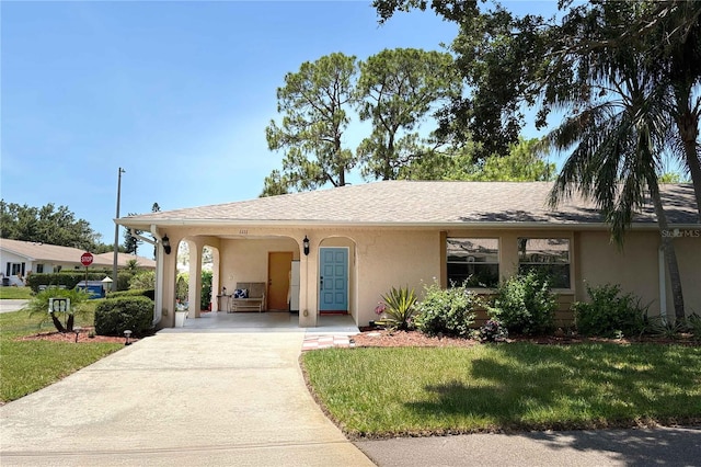 1111 Harefield Cir, Sun City Center, FL 33573 - view of front of property with stucco siding, driveway, and a front yard
