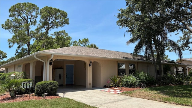 1111 Harefield Cir, Sun City Center, FL 33573 - ranch-style home with stucco siding, driveway, and a carport