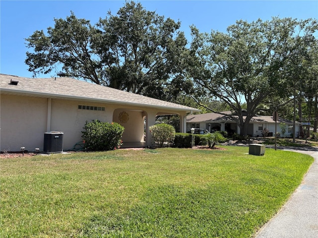 1111 Harefield Cir, Sun City Center, FL 33573 - view of front of property with central AC, a front yard, and stucco siding