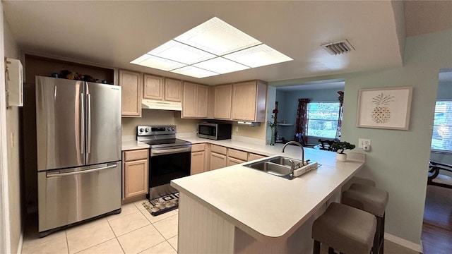 1111 Harefield Cir, Sun City Center, FL 33573 - kitchen with appliances with stainless steel finishes, under cabinet range hood, a sink, a peninsula, and light countertops