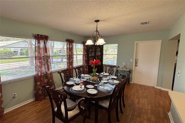 1111 Harefield Cir, Sun City Center, FL 33573 - dining room featuring wood finished floors, plenty of natural light, a textured ceiling, a chandelier, and baseboards