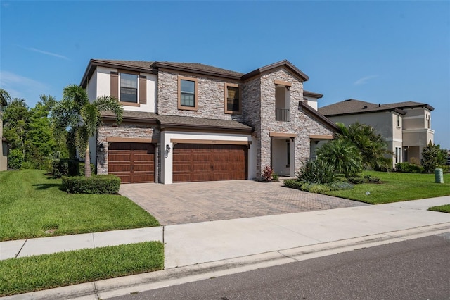 8932 Isabella Cir, Parrish, FL 34219 - view of front of property featuring stone siding, a garage, stucco siding, and a front yard
