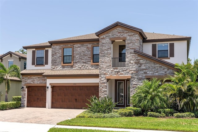 8932 Isabella Cir, Parrish, FL 34219 - view of front of home with an attached garage, stucco siding, decorative driveway, stone siding, and a shingled roof