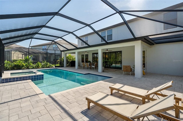 8932 Isabella Cir, Parrish, FL 34219 - view of pool with a ceiling fan, a patio area, a pool with connected hot tub, and glass enclosure