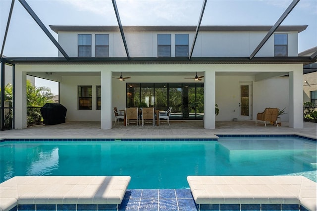 8932 Isabella Cir, Parrish, FL 34219 - back of house with ceiling fan, a patio, stucco siding, an outdoor pool, and a lanai
