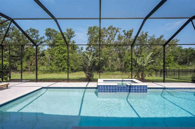 8932 Isabella Cir, Parrish, FL 34219 - view of swimming pool featuring glass enclosure, a pool with connected hot tub, and a patio area