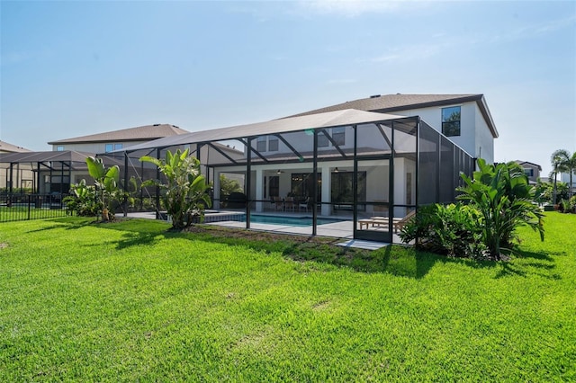 8932 Isabella Cir, Parrish, FL 34219 - rear view of property featuring a lawn, an outdoor pool, a patio, glass enclosure, and stucco siding