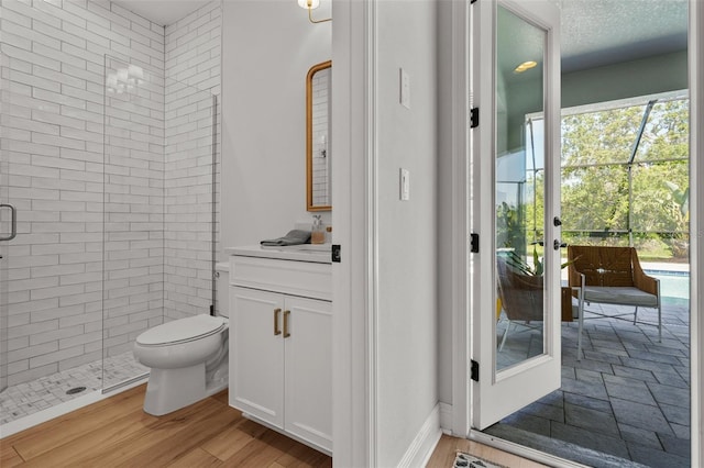 8932 Isabella Cir, Parrish, FL 34219 - bathroom featuring vanity, a shower stall, toilet, wood finished floors, and french doors