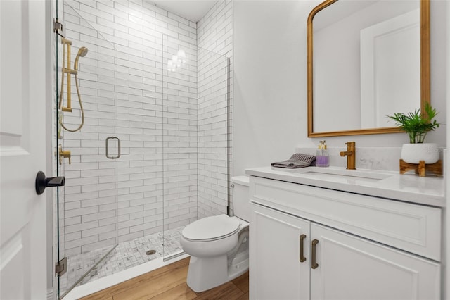 8932 Isabella Cir, Parrish, FL 34219 - full bathroom with vanity, a shower stall, toilet, and wood finished floors